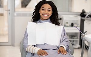 Woman sitting in a dental chair and smiling