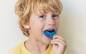 Young child with blue mouthguard