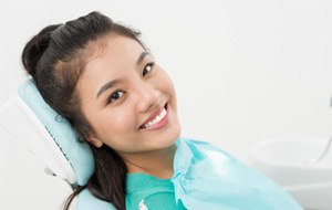 Woman with a bright smile sitting in dental chair