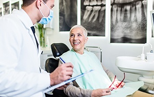 Happy patient talking with dentist