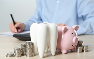 Coins next to a piggy bank