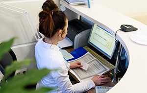 Receptionist working at a desk